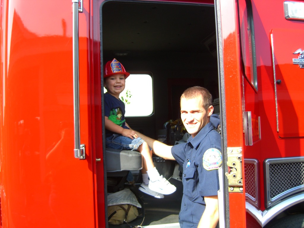 Exploring the fire truck at a community event